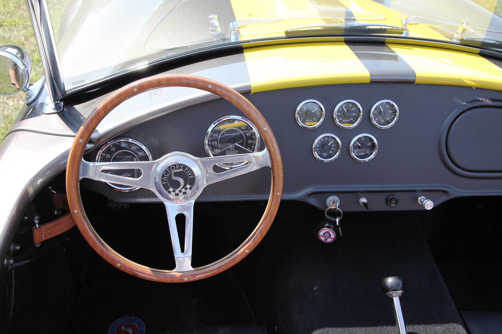 Wood-rimmed steering wheel and Speedhut gauge cluster